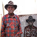 Uncle Badger Bates with portrait for <i>Barka: The Forgotten River</i> exhibition by Justine Muller.