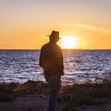Uncle Badger Bates watches the sun set over Menindee Lake, the largest lake of the Menindee Lakes system.