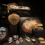 In 1910, a group of Indigenous Canadian performers was brought to Australia for a Wild West-style show. When the venture failed, their costumes and artefacts were sold to help fund their return to Canada. A dealer sold this collection to the Museum in 1912, including the large raven head mask hanging in this showcase.