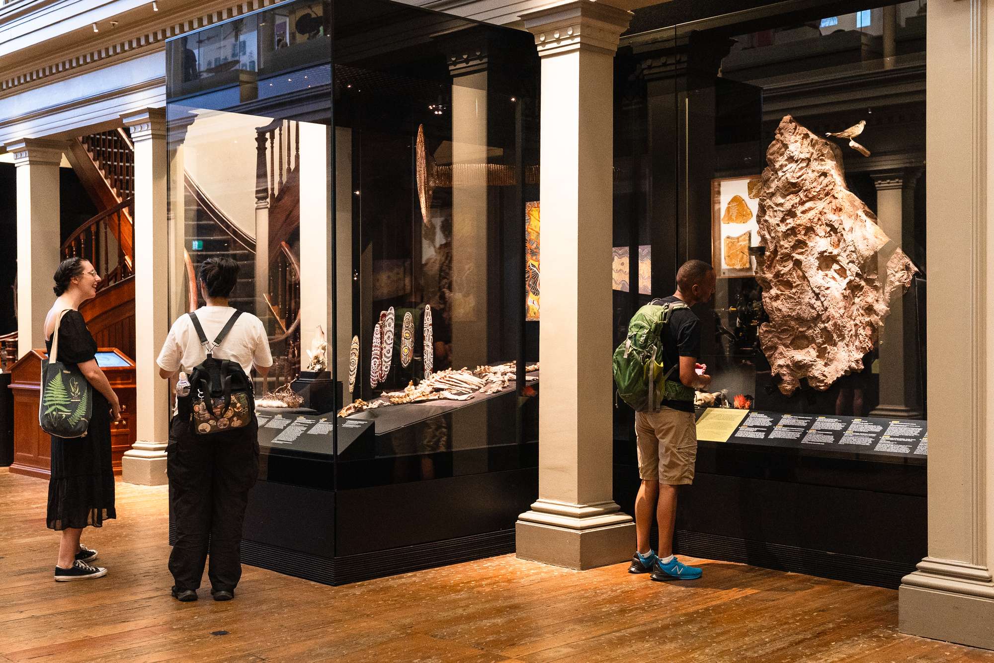 Visitors examine display cabinets in the Australian Museum's Westpac Long Gallery.