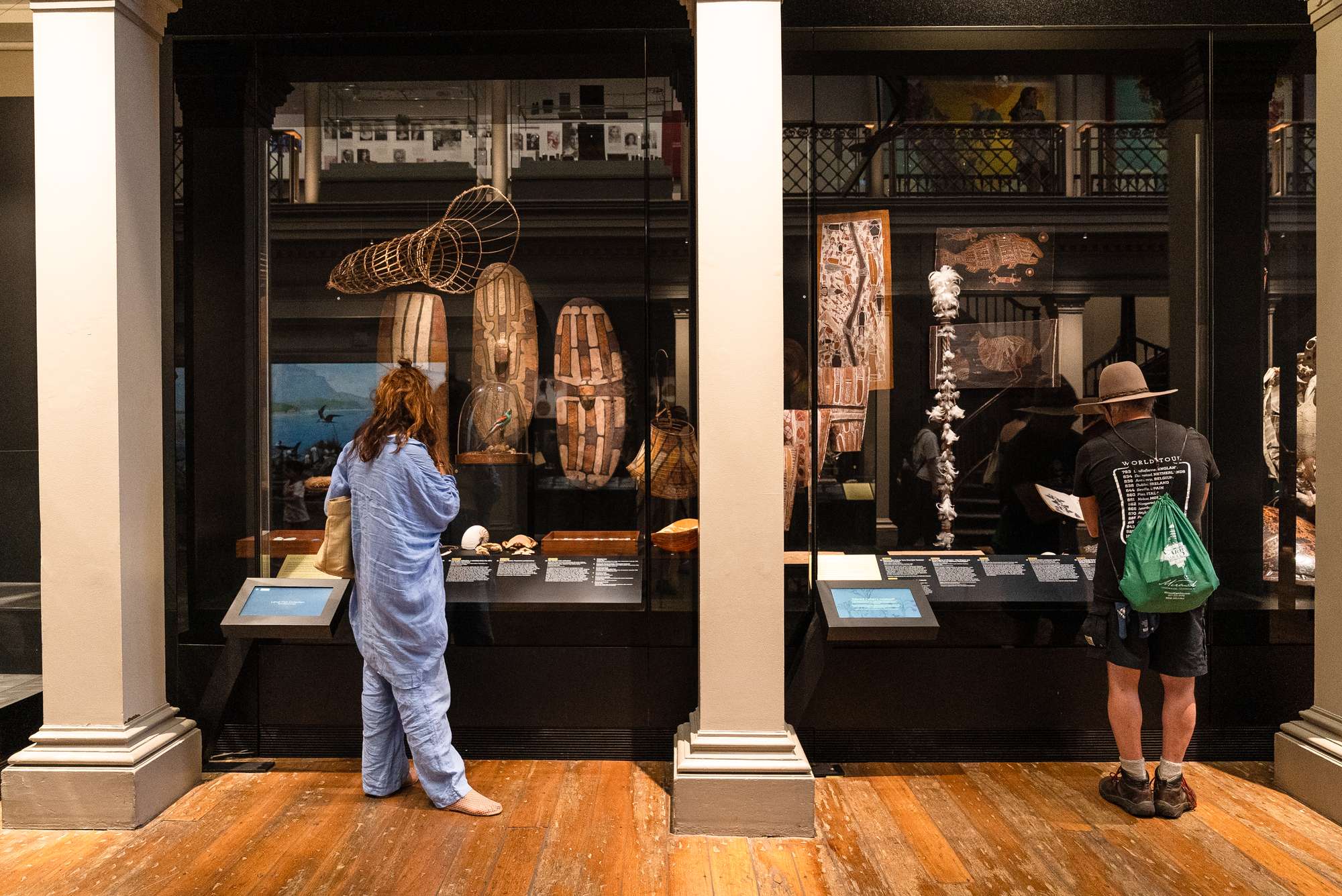 Visitors examine display cabinets in the Australian Museum's Westpac Long Gallery.