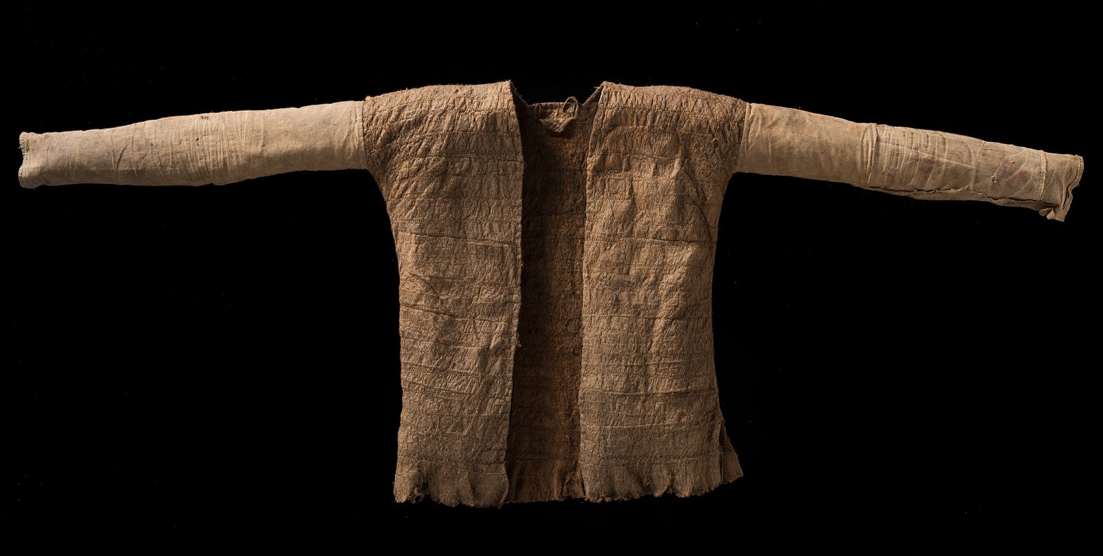 A worn, long-sleeved jacket made from barkcloth, displayed with arms outstretched.