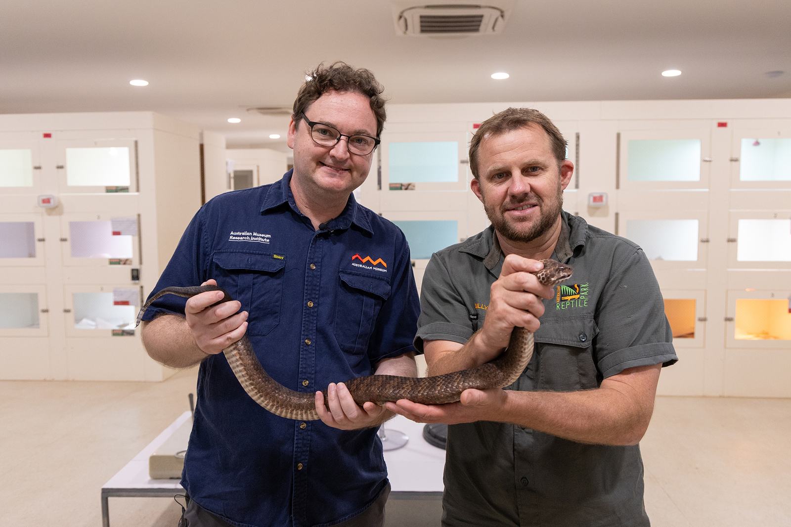 Dane Trembath (L) and Manager Billy Collett (R) holding Shazza the Death Adder