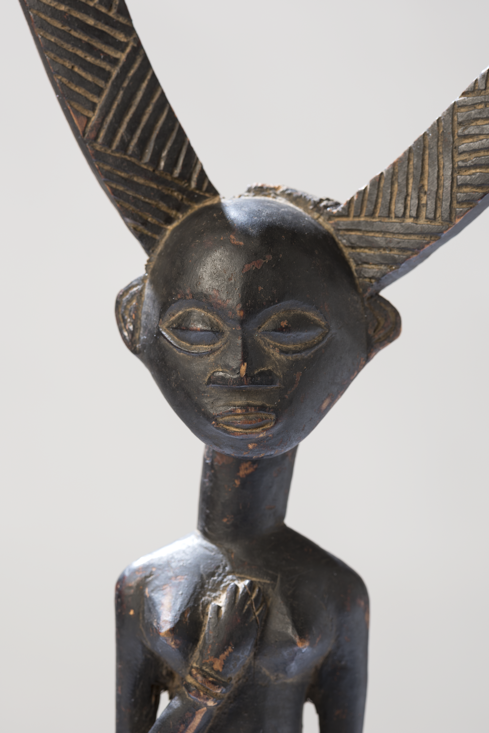 Striking carved wooden bow-stand belonging to a high chief of the Luba people of Katanga.