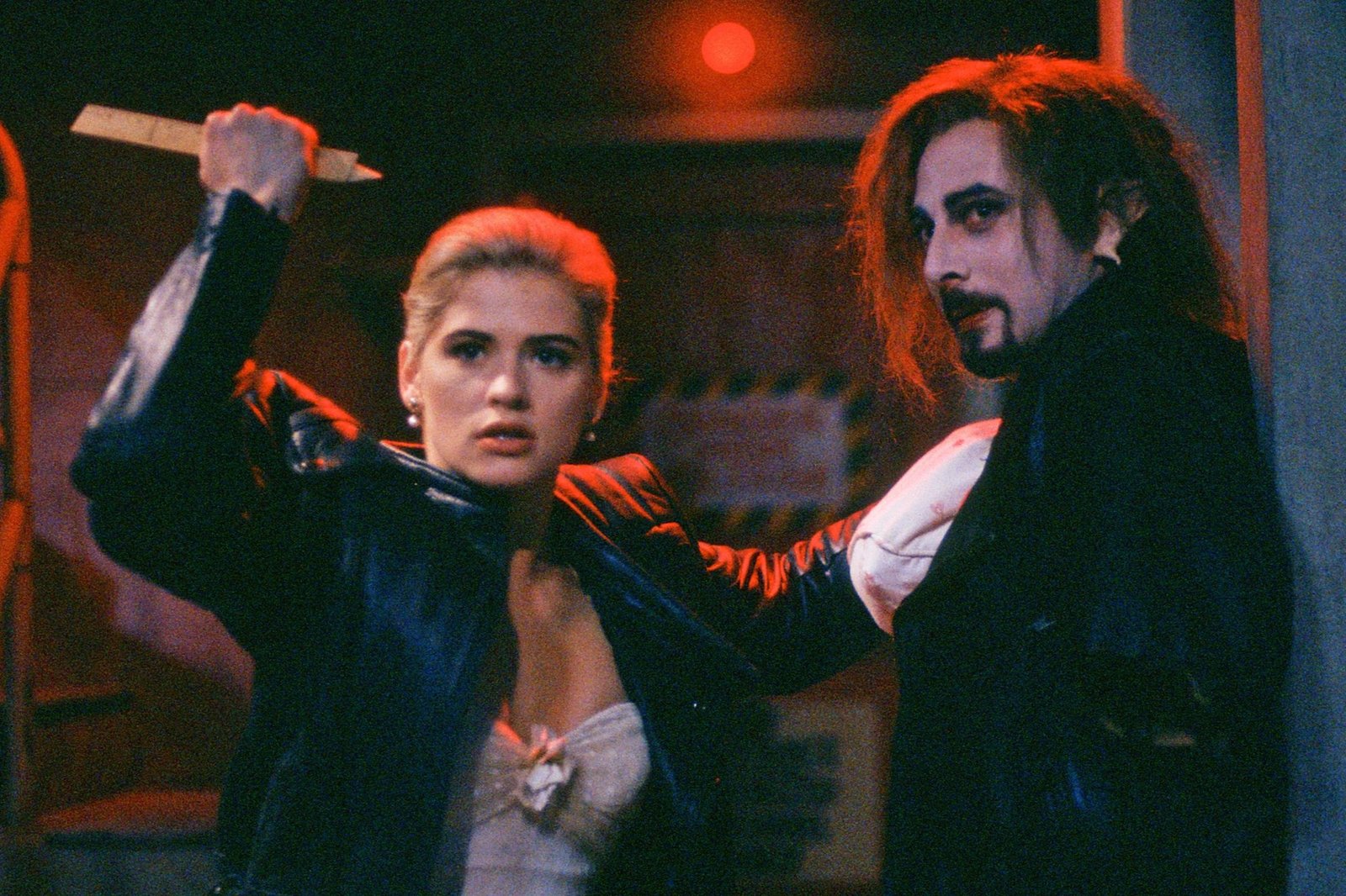 A still from Buffy the Vampire Slay, with Buffy holding a wooden stake.
