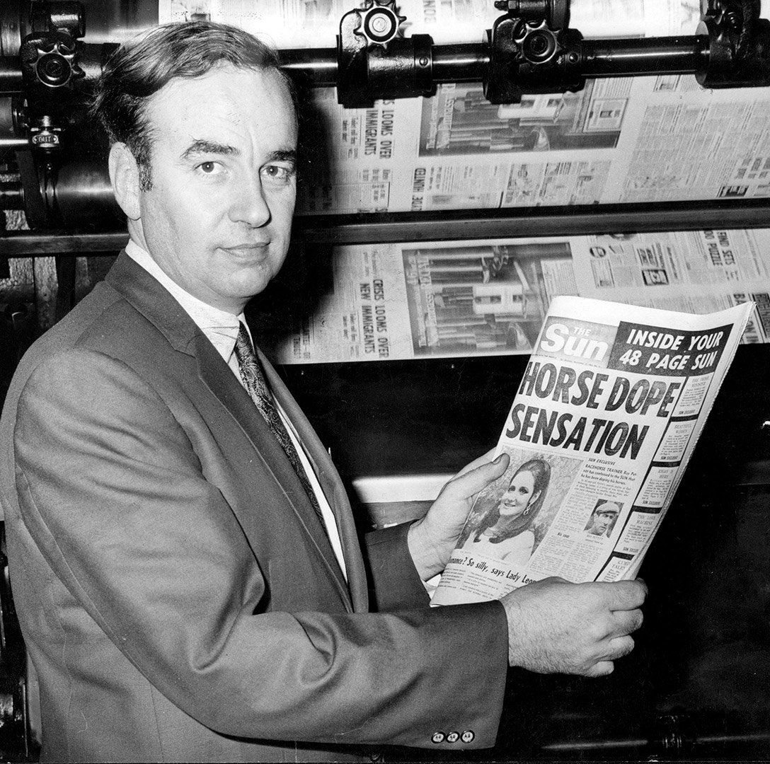 Rupert Murdoch holding a copy of London newspaper