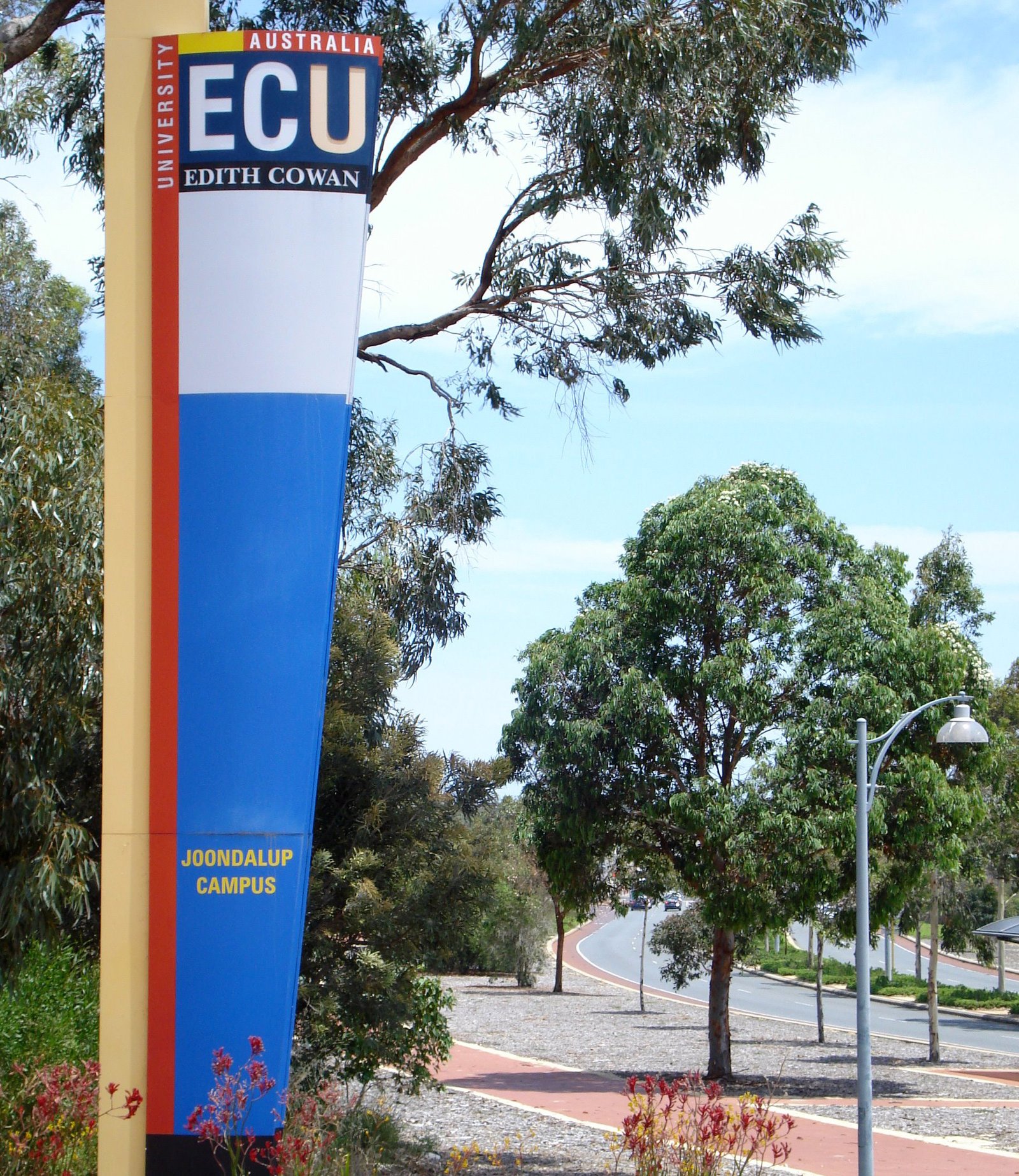 Edith Cowan University sign with a road and trees in the background