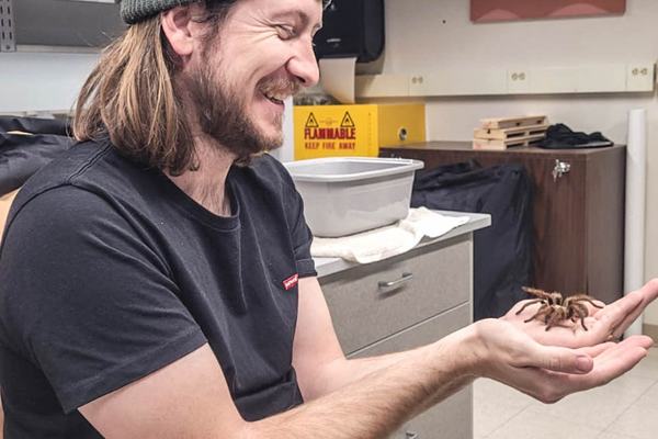 Dr Ethan Briggs holding a North American Aphonopelma tarantula