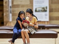 Children in Australian Museum Hintze Hall looking at map