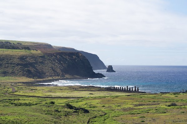 Landscape of Rapa Nui (Easter Island) with stone moai along shoreline.