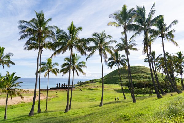 Landscape of Rapa Nui (Easter Island) with stone moai along shoreline.