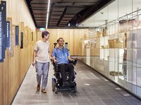 Man who uses a wheelchair and friend on Shop Ramp