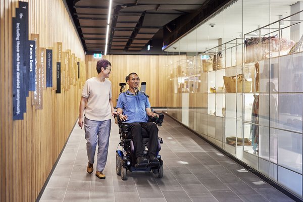 Man who uses a wheelchair and friend on Shop Ramp