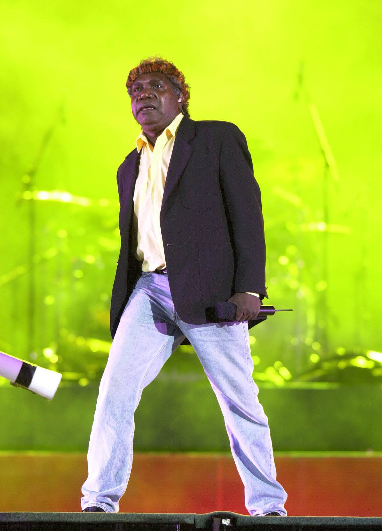 Yothu Yindi on stage, 2000 ceremony, appearing against a green-lit backstage.