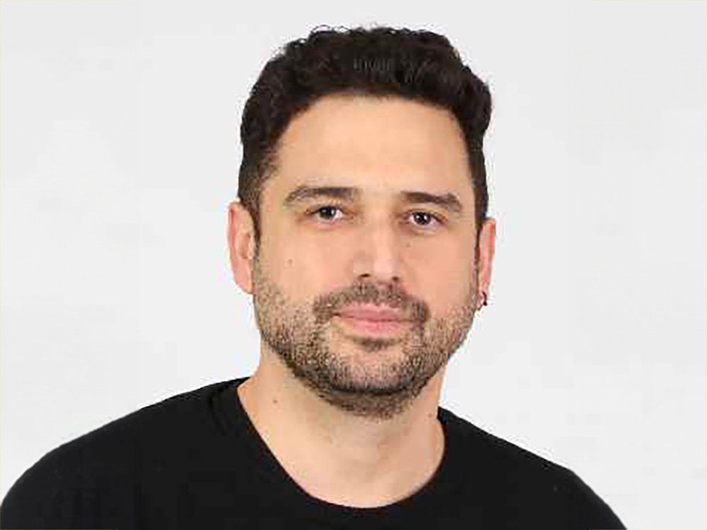 Headshot of Patricio Cabello facing the camera against a light background, with short dark hair