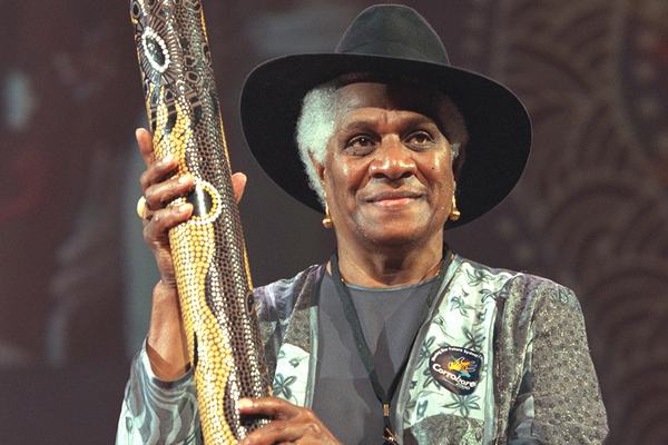 Evelyn Scott, holding a rain stick
