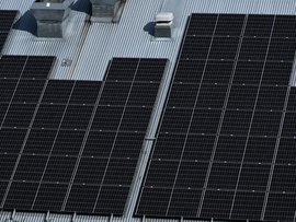 Solar panels are seen on a industrial building