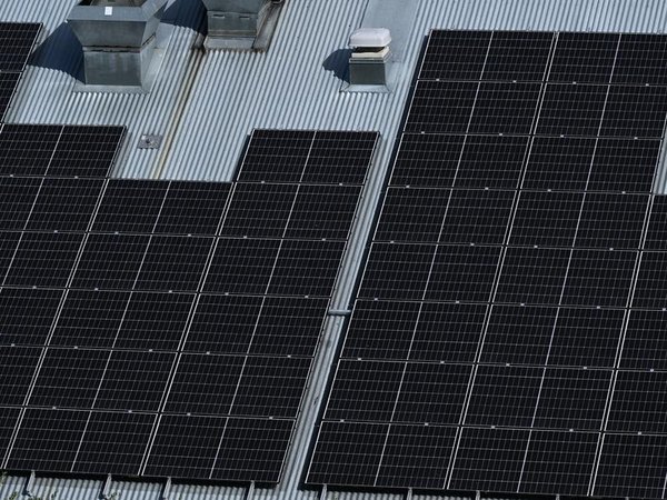 Solar panels are seen on a industrial building