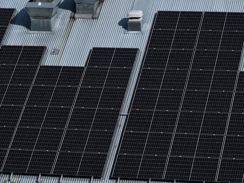 Solar panels are seen on a industrial building