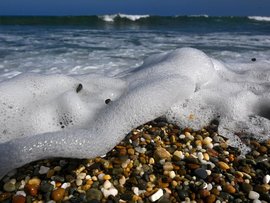 waves washing across pebbles on a beach