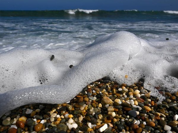 waves washing across pebbles on a beach