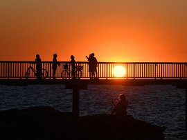 People watch the sunset in Darwin