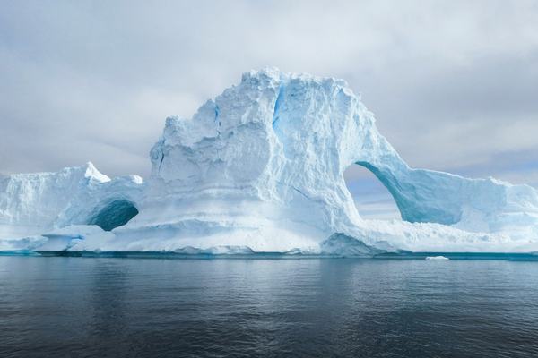 Snow covered mountains and ice along the Antarctic coast