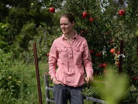 Sophie Nichols walks through her orchard