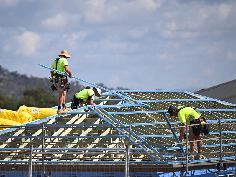 Roofers are seen working at a building site