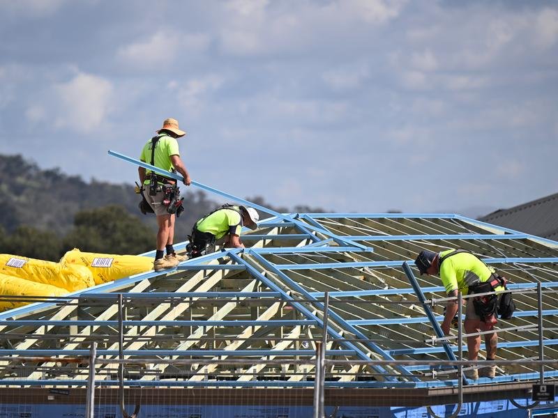 Roofers are seen working at a building site