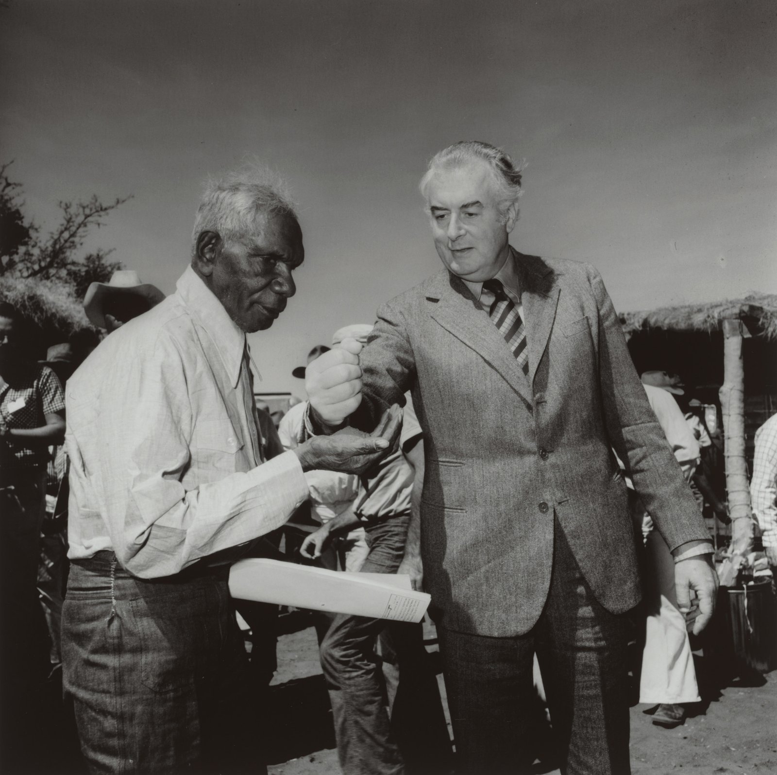 Whitlam pouring sand into Vincent Lingiari’s hand