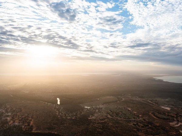 An aerial view of sun flaring through cloud