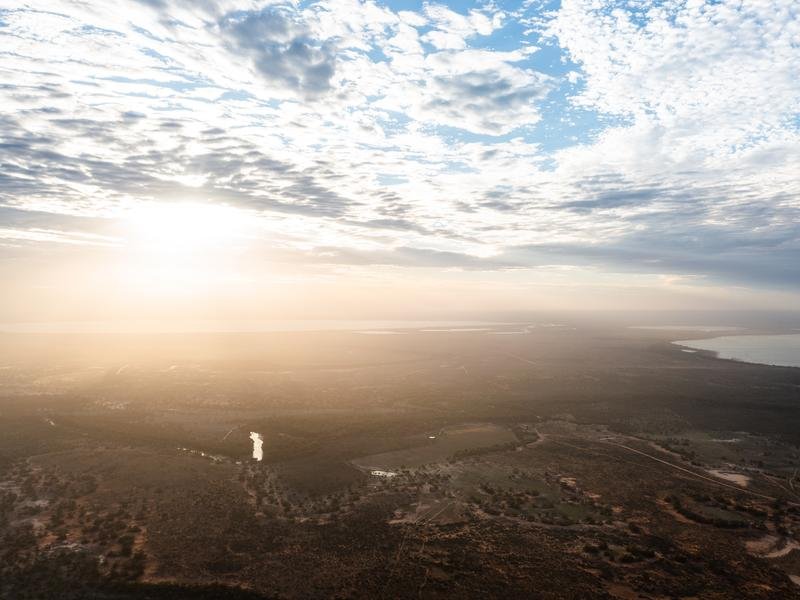 An aerial view of sun flaring through cloud