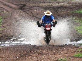 A farmer on his motorbike after some rain (file)