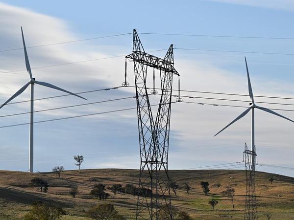 Power-generating windmill turbines and electricity pylons (file image)
