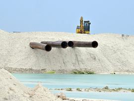A digger and pipes are seen at the Tuvalu Coastal Adaptation Project
