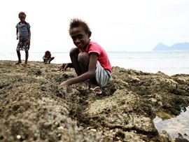 Children collect sea snails in Vanuatu