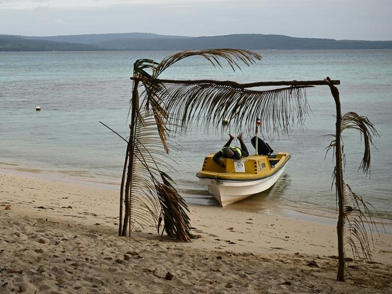 A ferry operator takes a break on his boat in Vanuatu